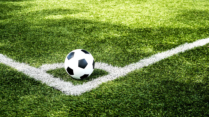 足球场上的球在绿色草地上，足球场上的背景纹理