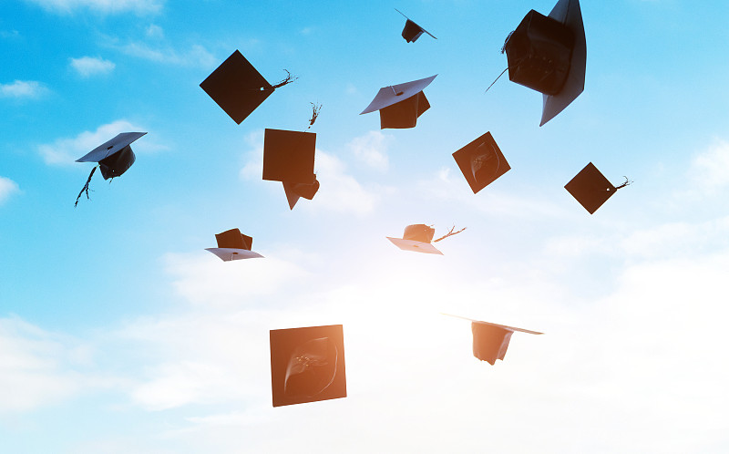 一群毕业帽被抛向空中