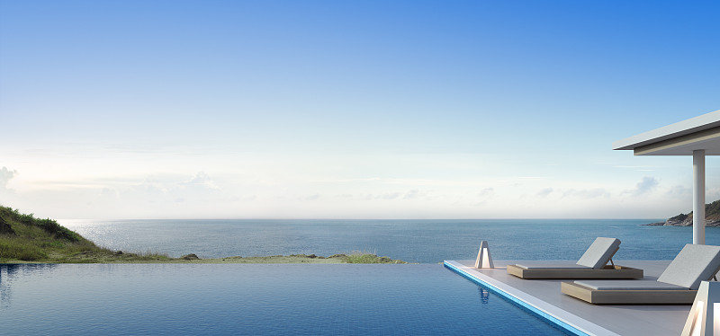 豪华海滩别墅海景游泳池和露台在现代设计，躺椅在木制甲板上度假的家或酒店