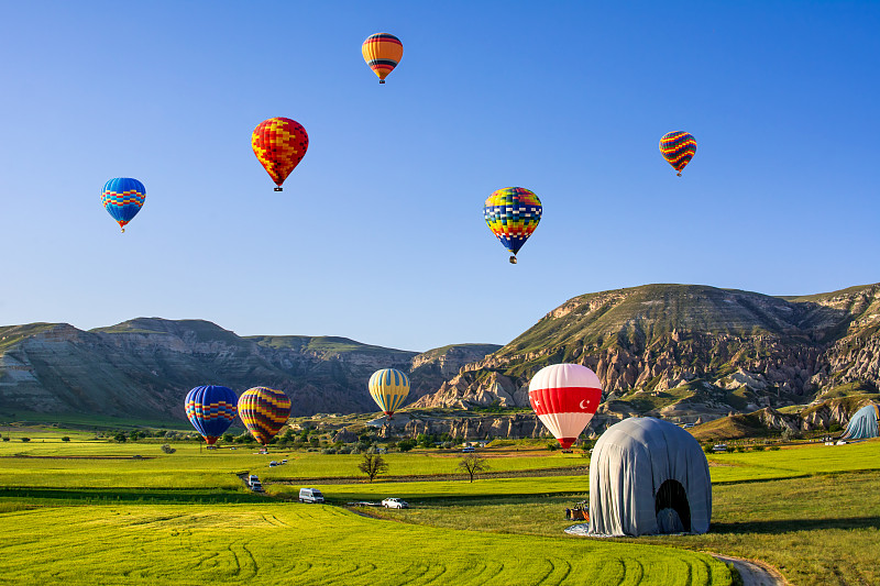 热气球飞过卡帕多西亚。卡帕多西亚是世界上最适合乘坐热气球的地方之一，土耳其卡帕多西亚的戈雷米。