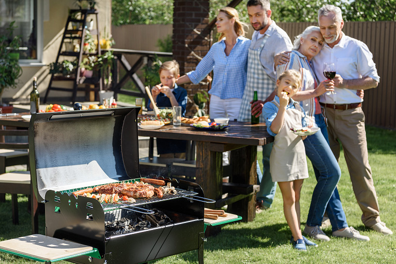 快乐的多代家庭在阳光明媚的一天在露台上吃午餐