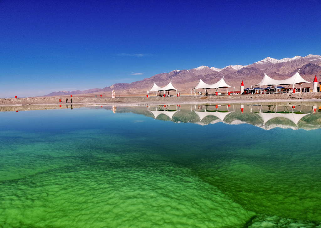 清晨的翡翠湖岸边的山峰建筑物倒影在盐湖上