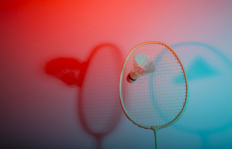 近毽子和羽毛球拍在红色的背景
