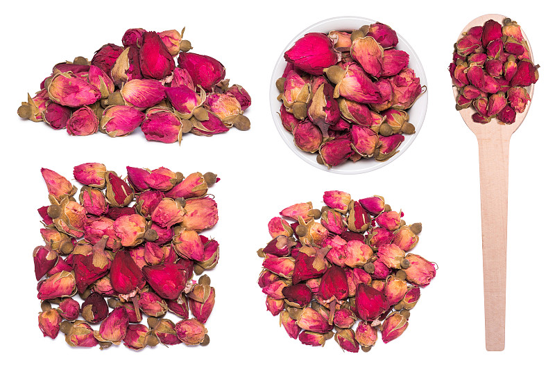 大套干玫瑰花蕾茶孤立在白色。木勺里的干玫瑰