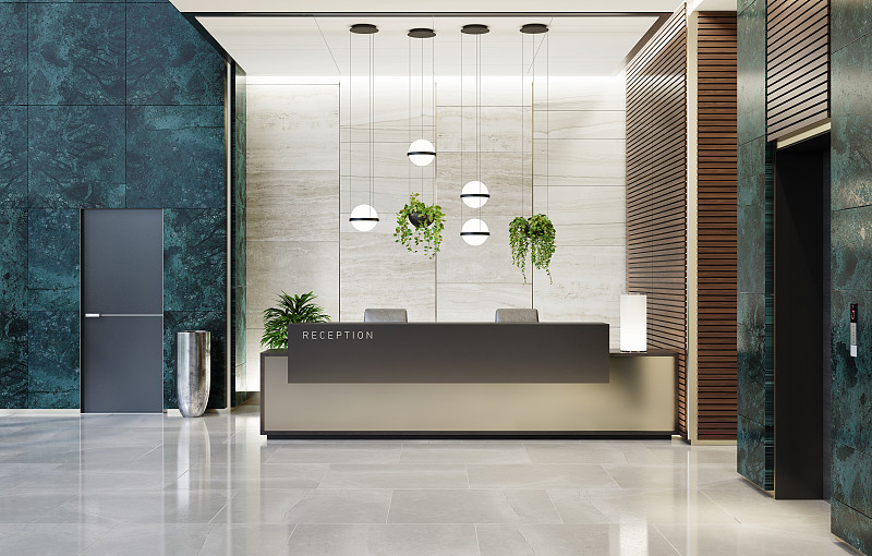 现代化的办公室大堂内部区域有电梯和楼梯和长长的接待台