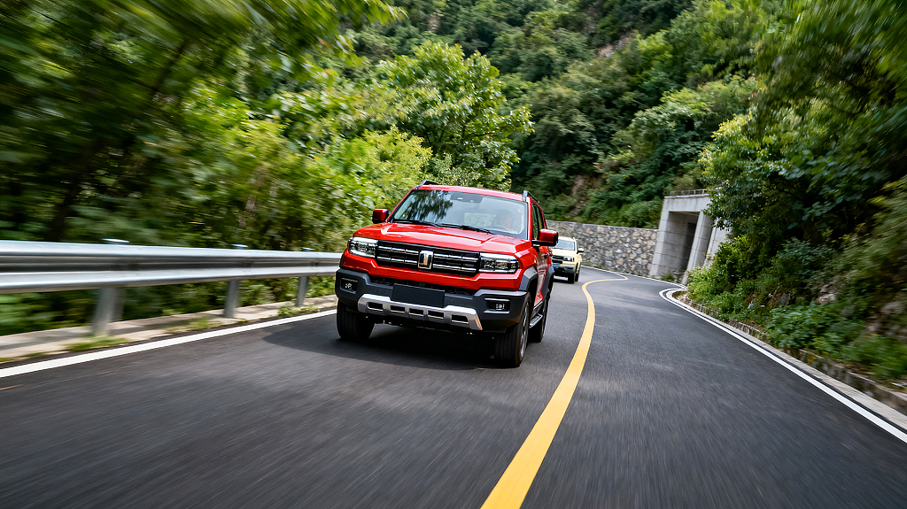 户外驾驶场景红色SUV在山林间的弯道上行驶公路植被越野山林马路