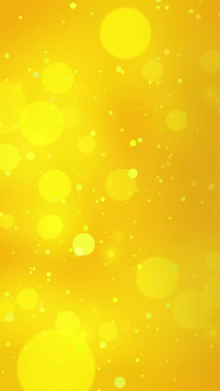 背景与闪烁的黄色粒子和散景。假期的设计。闪烁着魔法之光坠落的闪亮粒子。美丽的背景光。无缝循环股票视频黄色，五彩纸屑，奖项，散焦，全帧保存股票视频土耳其-中东