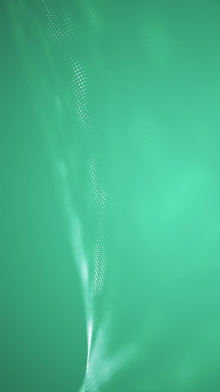 纯色流动粒子，技术视频背景，抽象未来无缝循环。技术数字波背景概念-美丽的运动波点纹理与发光离焦粒子。有网络或技术背景。蓝色